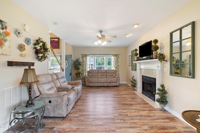 115 Spring Branch Dr, Four Oaks, NC 27524 - living room with a tiled fireplace, wood finished floors, a ceiling fan, and baseboards