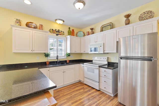 115 Spring Branch Dr, Four Oaks, NC 27524 - kitchen featuring white appliances, a sink, white cabinets, light wood finished floors, and recessed lighting