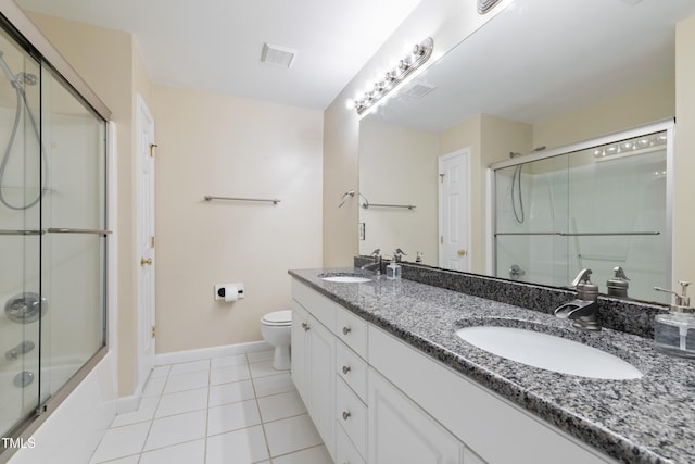 115 Spring Branch Dr, Four Oaks, NC 27524 - full bathroom with baseboards, double vanity, tile patterned flooring, toilet, and bath / shower combo with glass door