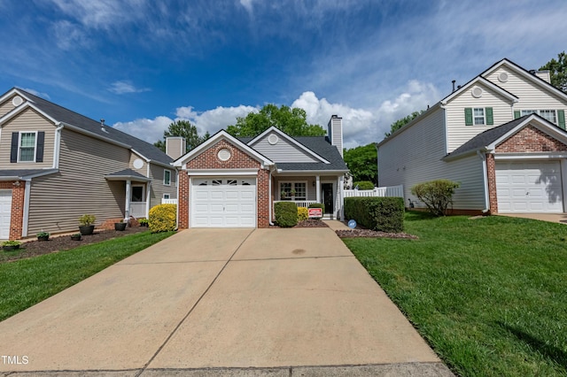 traditional home with brick siding, an attached garage, concrete driveway, and a chimney