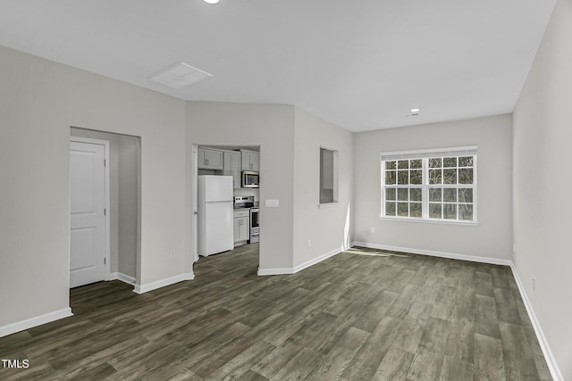 unfurnished living room featuring dark wood finished floors, baseboards, and recessed lighting