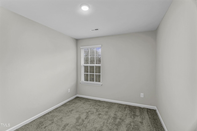 carpeted empty room with baseboards