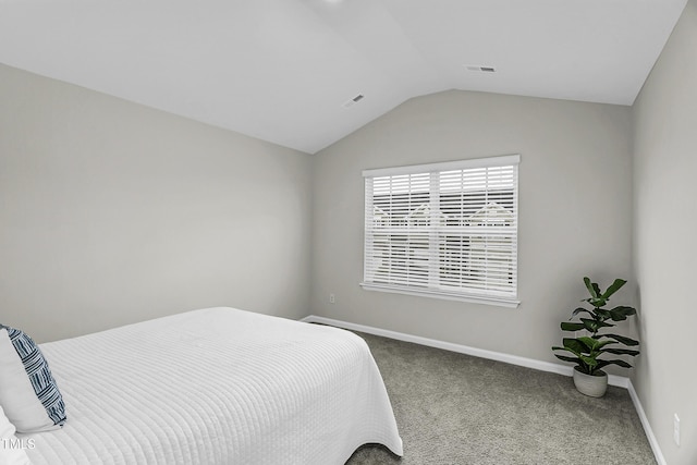 carpeted bedroom featuring lofted ceiling and baseboards