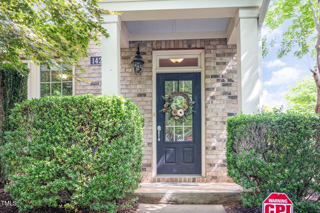 doorway to property featuring stone siding