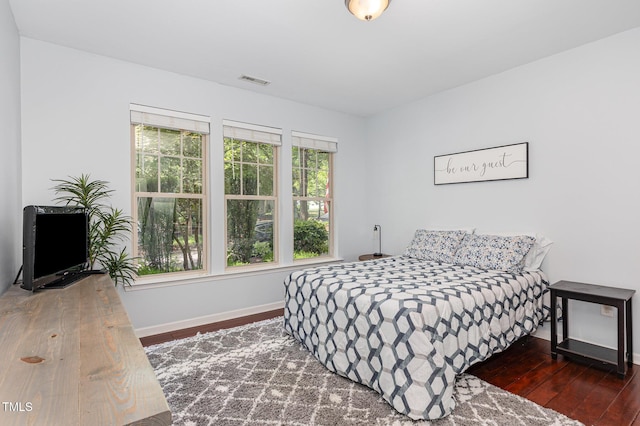 bedroom featuring baseboards and wood finished floors