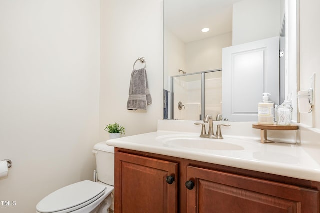 full bath with toilet, a stall shower, and vanity