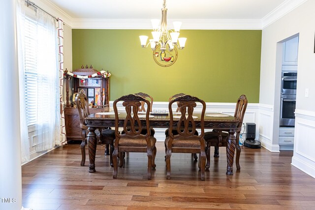 dining room with ornamental molding, a chandelier, and hardwood / wood-style flooring