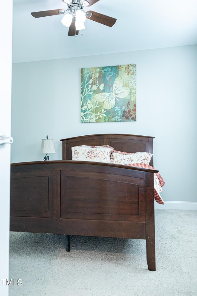 carpeted bedroom featuring ceiling fan and baseboards