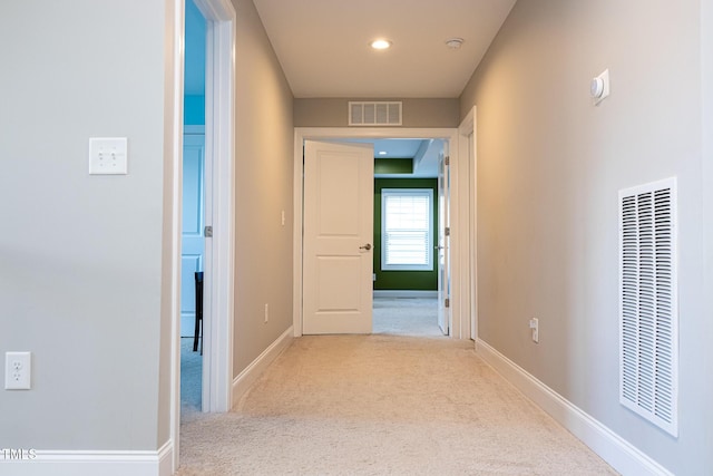hall with carpet, a heating unit, baseboards, and recessed lighting