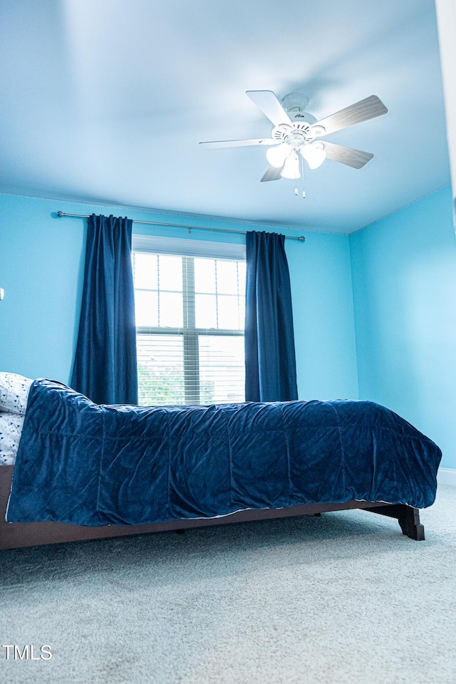 carpeted bedroom featuring a ceiling fan