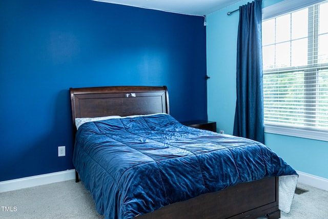 bedroom with carpet and baseboards