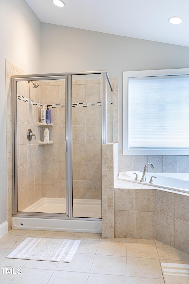 bathroom with tile patterned flooring, a shower stall, and a bath