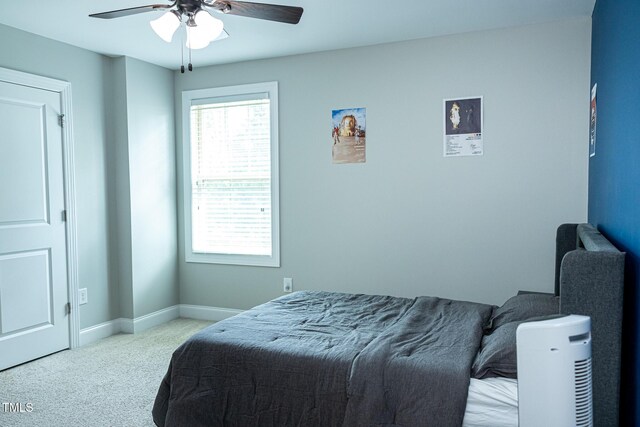 carpeted bedroom with baseboards and ceiling fan