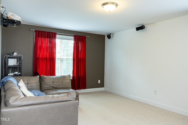 living area featuring carpet flooring and baseboards