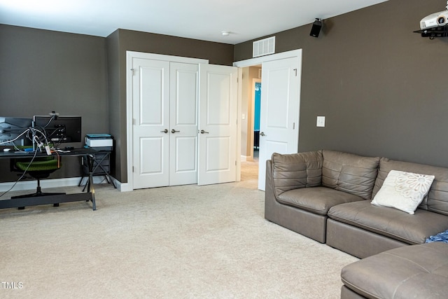 living area with carpet, a desk, and baseboards
