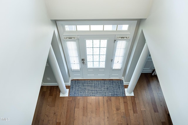 entryway with wood finished floors and baseboards