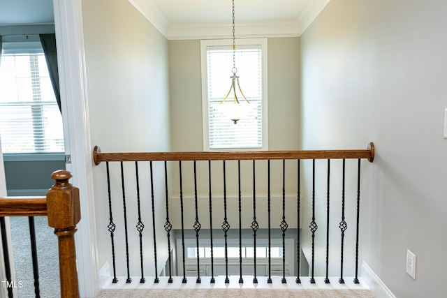 stairs featuring crown molding and baseboards