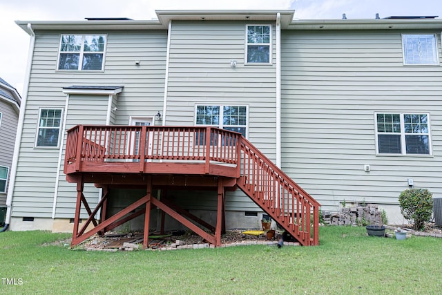 rear view of property featuring a deck, a yard, and stairway