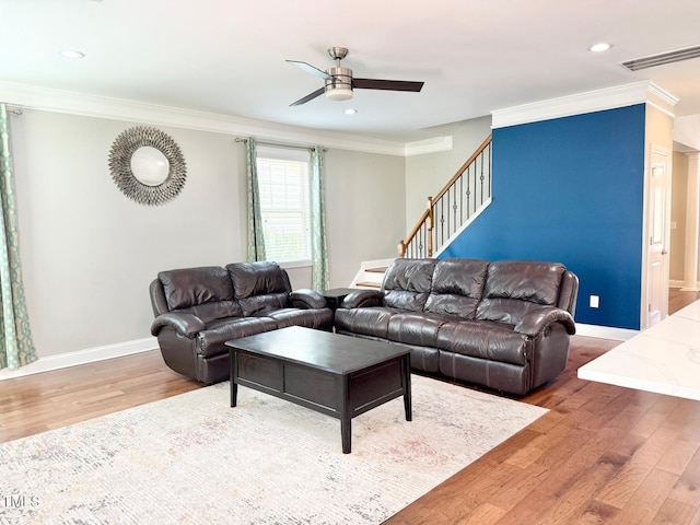5016 Trembath Ln, Cary, NC 27519 - living room with wood finished floors, a ceiling fan, ornamental molding, stairs, and baseboards