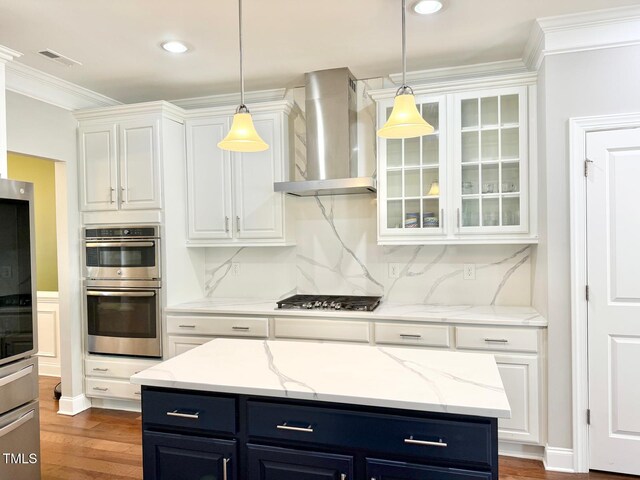 5016 Trembath Ln, Cary, NC 27519 - kitchen featuring wall chimney exhaust hood, stainless steel appliances, blue cabinetry, white cabinets, and ornamental molding