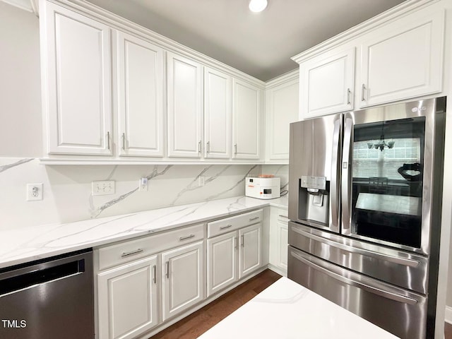 5016 Trembath Ln, Cary, NC 27519 - kitchen with appliances with stainless steel finishes, white cabinetry, light stone countertops, and dark wood-style floors
