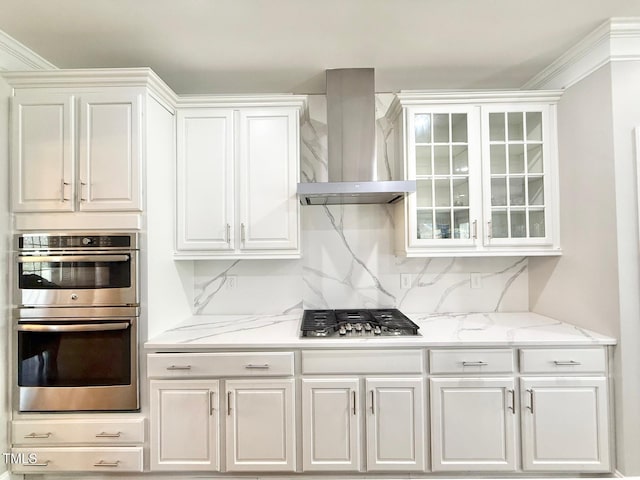 5016 Trembath Ln, Cary, NC 27519 - kitchen featuring wall chimney range hood, stainless steel appliances, white cabinets, and glass insert cabinets