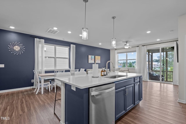 159 Wood Orchid Ln, Garner, NC 27529 - kitchen with dishwasher, a sink, open floor plan, wood finished floors, and light countertops