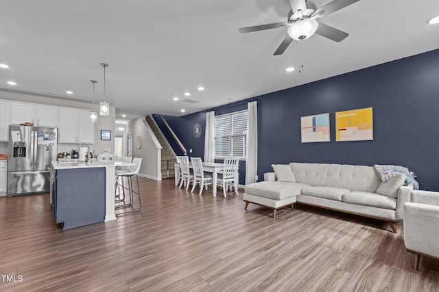 159 Wood Orchid Ln, Garner, NC 27529 - living room with recessed lighting, ceiling fan, dark wood-style floors, baseboards, and stairs