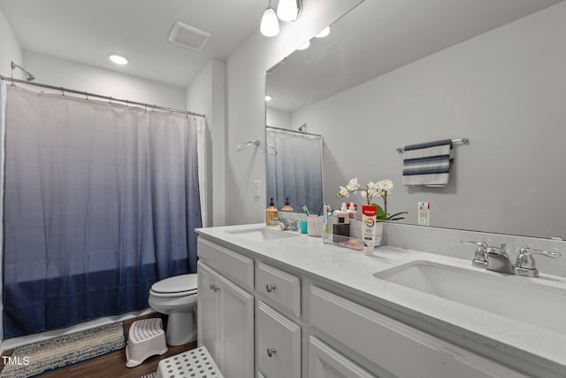 159 Wood Orchid Ln, Garner, NC 27529 - full bath with double vanity, toilet, and a shower with shower curtain