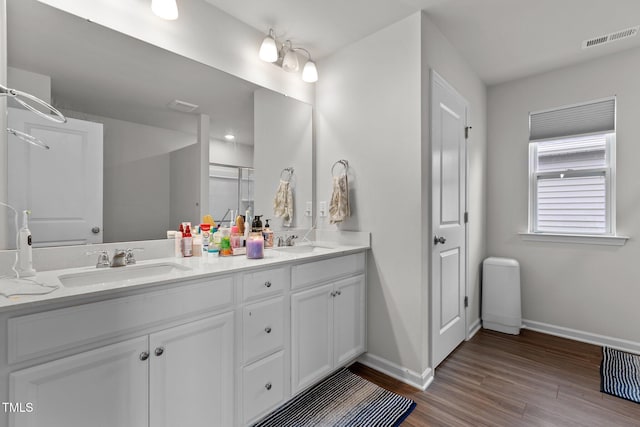 159 Wood Orchid Ln, Garner, NC 27529 - bathroom with baseboards, wood finished floors, a shower stall, and double vanity