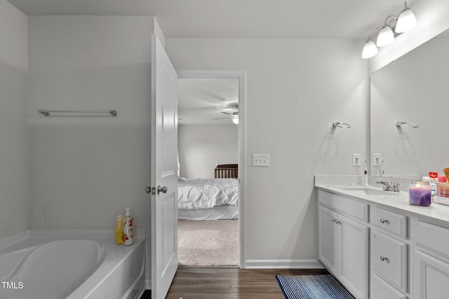 159 Wood Orchid Ln, Garner, NC 27529 - bathroom featuring wood finished floors, ensuite bathroom, a ceiling fan, vanity, and a garden tub