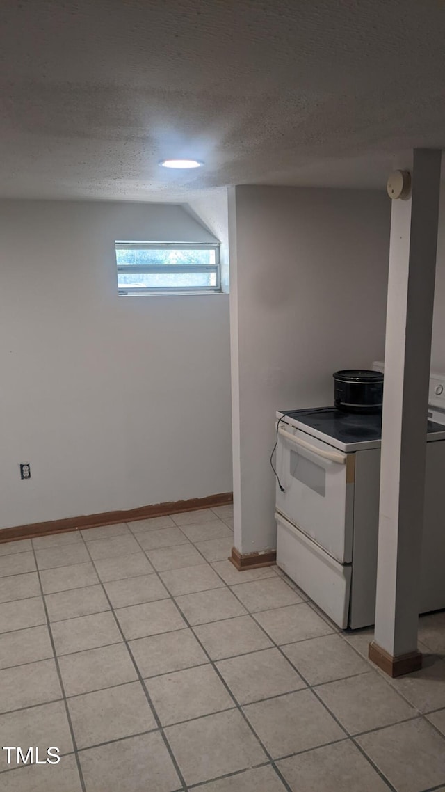 836 S Main St, Roxboro, NC 27573 - kitchen with white electric range oven, baseboards, light tile patterned floors, and a textured ceiling