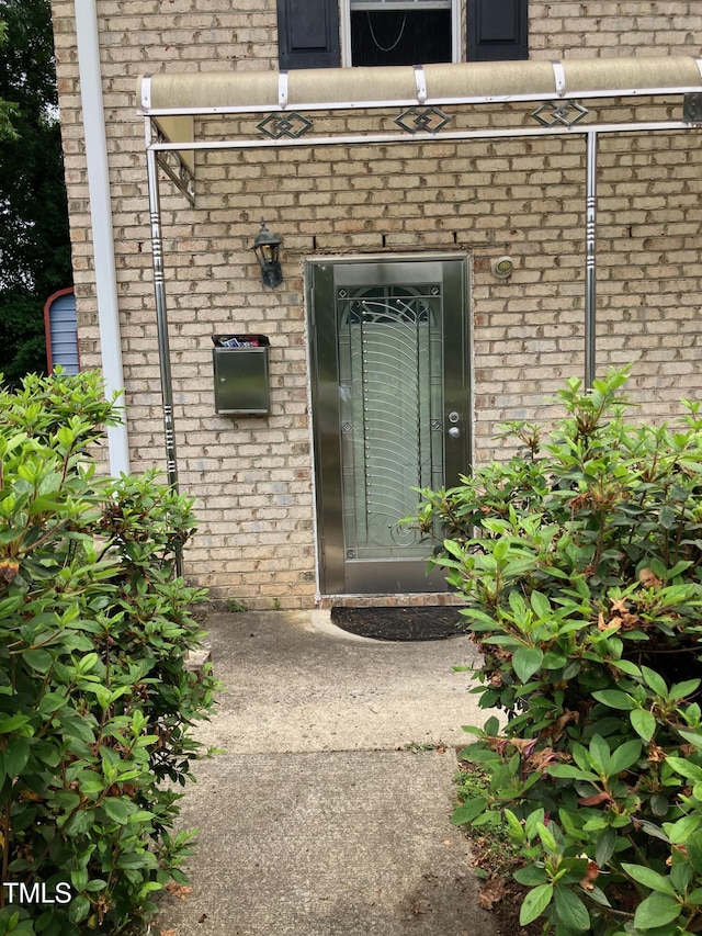 836 S Main St, Roxboro, NC 27573 - doorway to property with brick siding