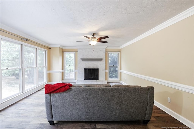 750 Magellan Ct, Fayetteville, NC 28311 - living area with a textured ceiling, a ceiling fan, ornamental molding, wood finished floors, and a fireplace