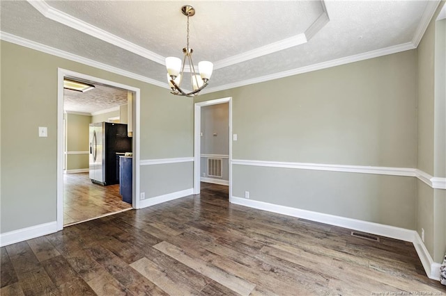 750 Magellan Ct, Fayetteville, NC 28311 - unfurnished room featuring a textured ceiling, dark wood-type flooring, a tray ceiling, a chandelier, and ornamental molding