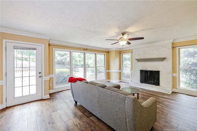 750 Magellan Ct, Fayetteville, NC 28311 - living area featuring a ceiling fan, dark wood-style floors, a textured ceiling, plenty of natural light, and ornamental molding