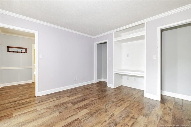 750 Magellan Ct, Fayetteville, NC 28311 - unfurnished bedroom with wood finished floors, crown molding, and a textured ceiling