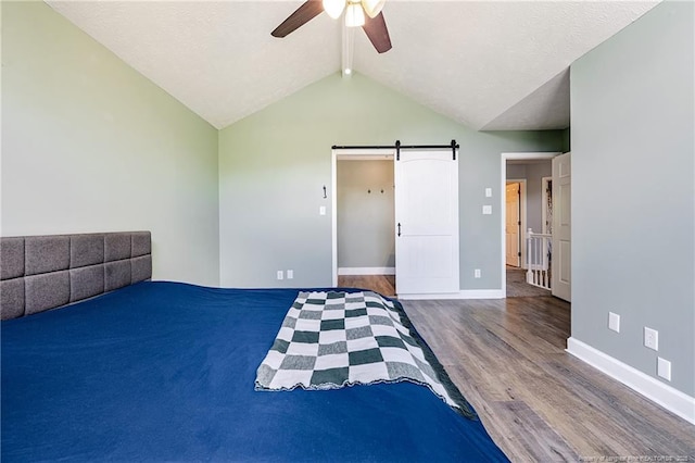750 Magellan Ct, Fayetteville, NC 28311 - unfurnished bedroom featuring a barn door, wood finished floors, and ceiling fan