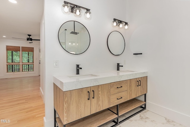 full bath featuring baseboards, ceiling fan, double vanity, and recessed lighting