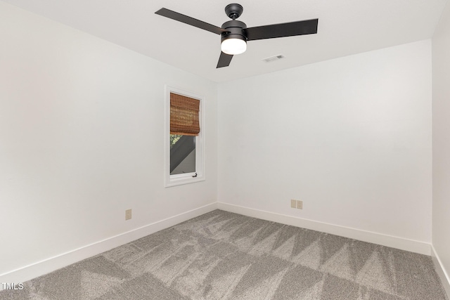 spare room featuring carpet flooring, baseboards, and a ceiling fan