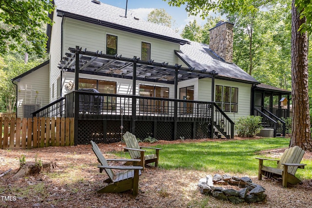 rear view of property with a fire pit, stairs, a pergola, a wooden deck, and a chimney