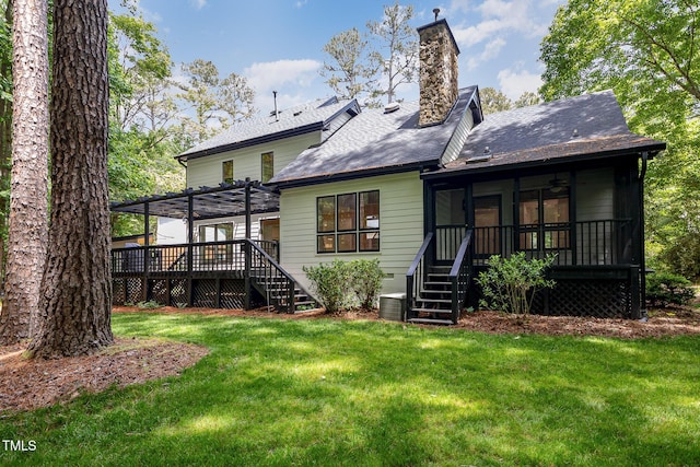 back of property with stairs, a pergola, a deck, and a yard