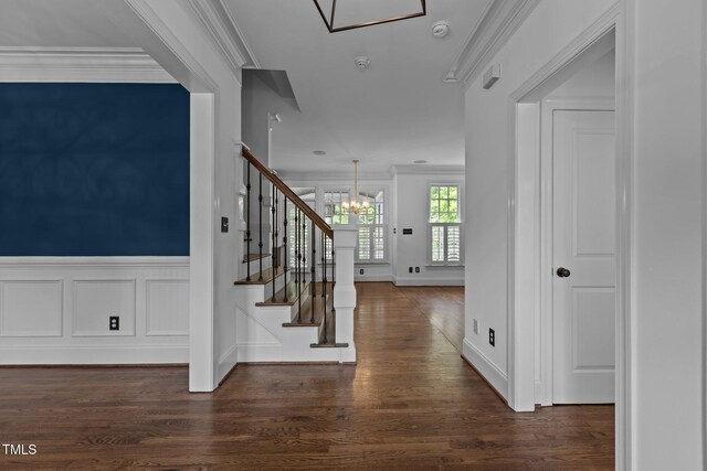 3323 Cheswick Dr, Raleigh, NC 27609 - foyer featuring a chandelier, crown molding, stairway, and dark wood-type flooring
