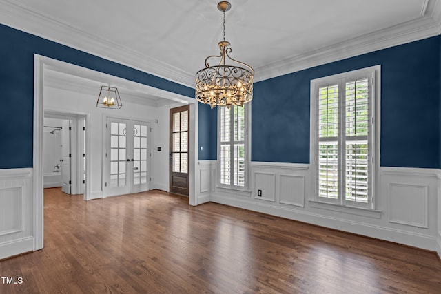 3323 Cheswick Dr, Raleigh, NC 27609 - unfurnished dining area featuring a chandelier, wainscoting, wood finished floors, ornamental molding, and french doors