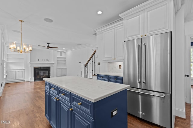 3323 Cheswick Dr, Raleigh, NC 27609 - kitchen with high quality fridge, blue cabinets, ceiling fan, white cabinets, and recessed lighting