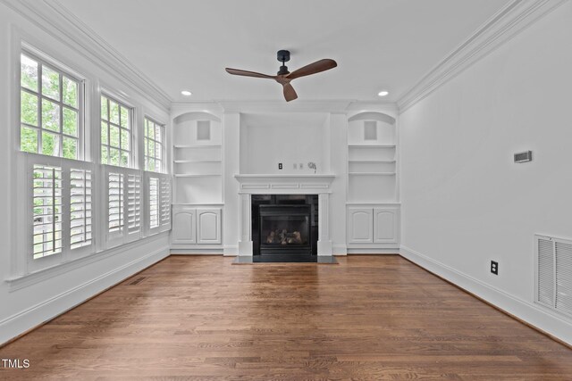 3323 Cheswick Dr, Raleigh, NC 27609 - unfurnished living room with ornamental molding, healthy amount of natural light, built in features, ceiling fan, and recessed lighting