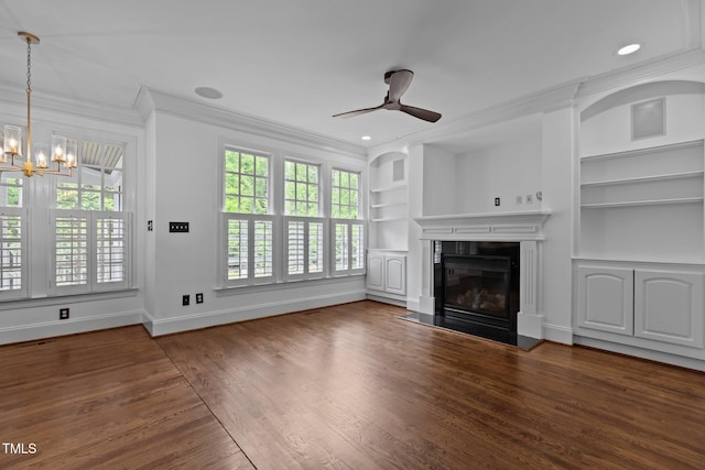 3323 Cheswick Dr, Raleigh, NC 27609 - unfurnished living room with crown molding, built in features, a chandelier, ceiling fan, and wood finished floors