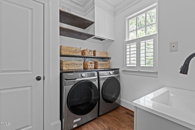 3323 Cheswick Dr, Raleigh, NC 27609 - clothes washing area with washer and clothes dryer, healthy amount of natural light, dark wood-style flooring, and baseboards