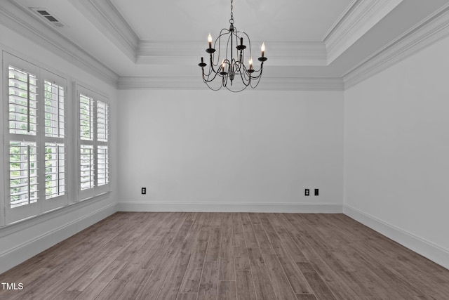3323 Cheswick Dr, Raleigh, NC 27609 - unfurnished room with a tray ceiling, wood finished floors, a chandelier, crown molding, and baseboards