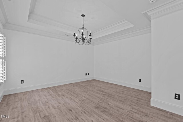 3323 Cheswick Dr, Raleigh, NC 27609 - unfurnished room featuring crown molding, a raised ceiling, a chandelier, wood finished floors, and baseboards